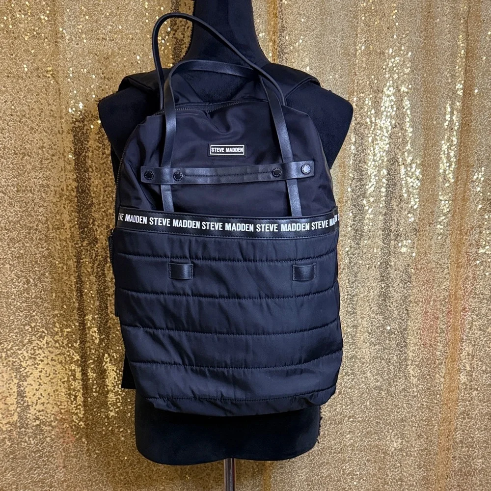 Steve Madden Bjodah Black Quilted Backpack with carry handles and branded strap